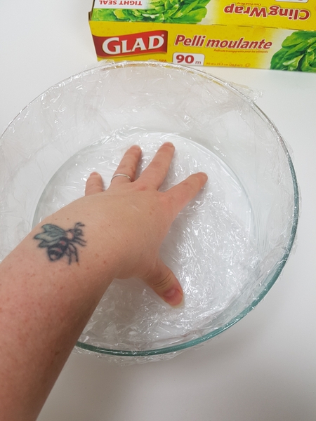 Line a shallow container with plastic wrap Line a shallow container with plastic wrap