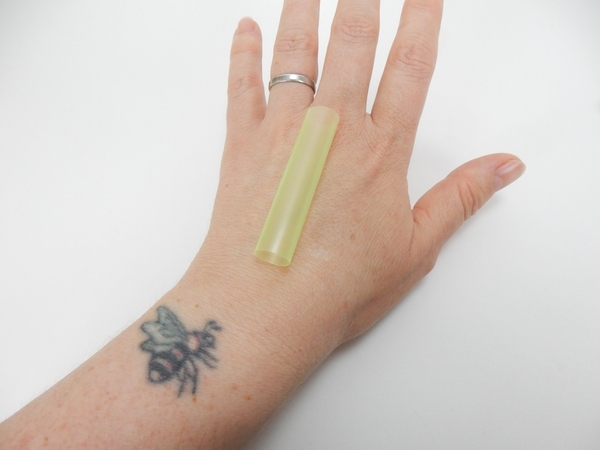 Measure and cut a drinking straw to fit on the top of your hand Measure and cut a drinking straw to fit on the top of your hand