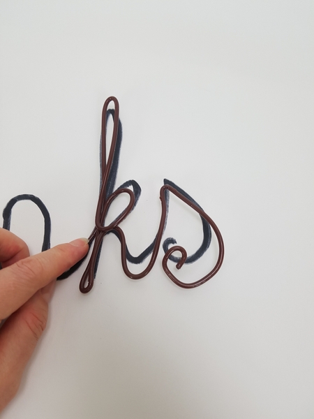 Bend thick wire to follow the script Bend thick wire to follow the script