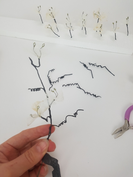 Carefully tape the tendrils and blossoms to the stem wire