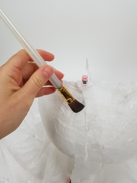 Glue the slit closed with a few strips of tissue paper and wood glue Glue the slit closed with a few strips of tissue paper and wood glue