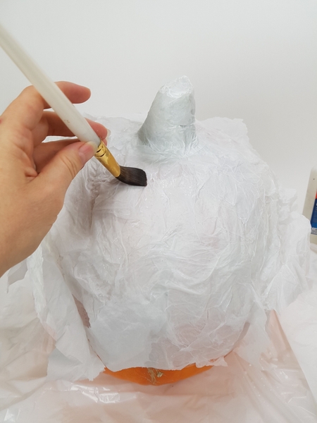 Place strips of tissue paper on the shape and paint with the wood glue