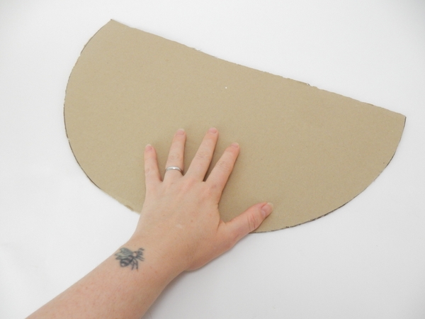 Cut a large cardboard circle to almost half. Cut a large cardboard circle to almost half.
