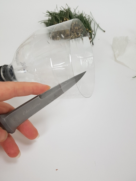 Cut a ring from a clear soda bottle. Cut a ring from a clear soda bottle.