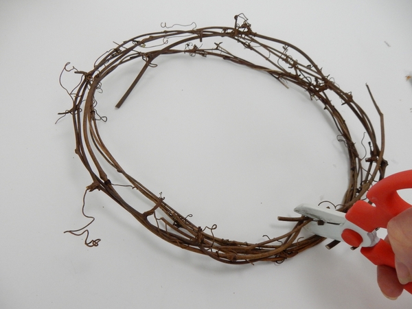 Cut two sections of a vine wreath for the skids Cut two sections of a vine wreath for the skids