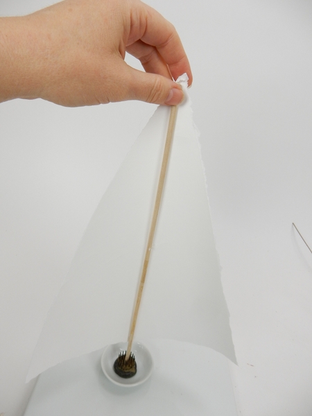 Glue the paper to the back of the dowel Glue the paper to the back of the dowel