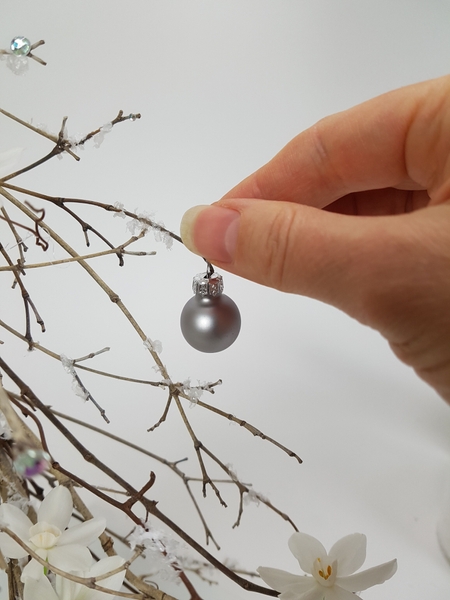 Hang a few baubles on the twig snipped branches Hang a few baubles on the twig snipped branches