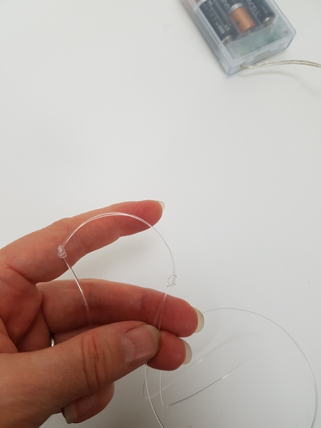 Knot the line on both sides from the mid point Knot the line on both sides from the mid point