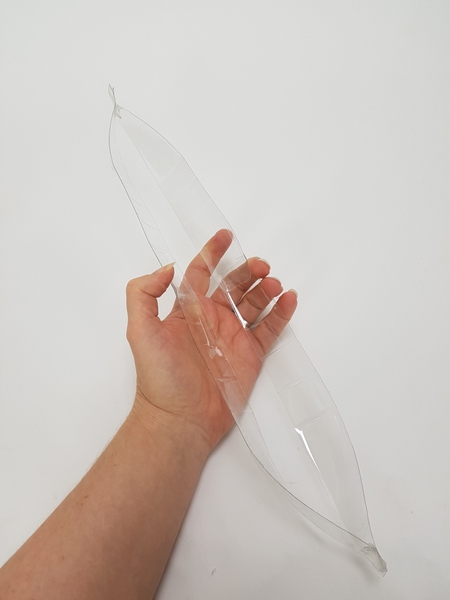 Connect the plastic at the top and the bottom to mimic the shape of a leaf Connect the plastic at the top and the bottom to mimic the shape of a leaf
