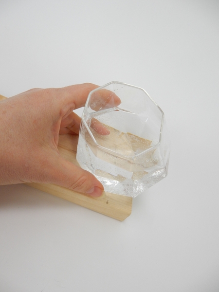 Place a small vase on a display surface Place a small vase on a display surface