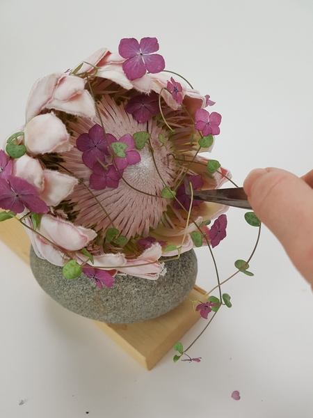 Place the Hydrangea florets into the flower head Place the Hydrangea florets into the flower head