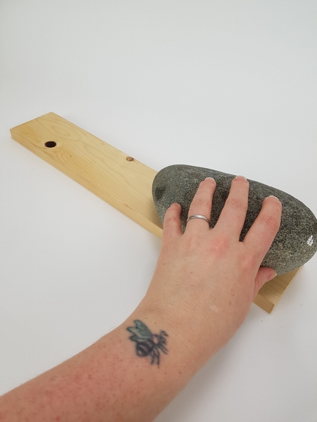 Rest a rock or pebble on a display surface Rest a rock or pebble on a display surface