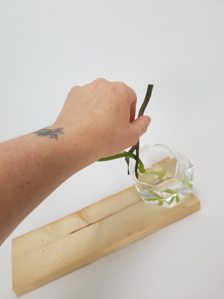 Wiggle the twig so that the flower stem fits snugly to keep it in place Wiggle the twig so that the flower stem fits snugly to keep it in place