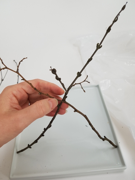 Cross the twigs so that they hook into each other Cross the twigs so that they hook into each other