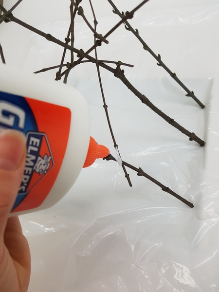 Frost the twigs with a small drop of wood glue Frost the twigs with a small drop of wood glue
