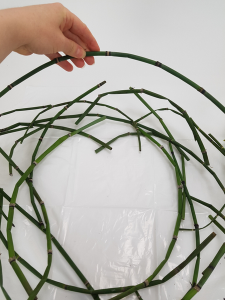 Stack the curved stems to create a wreath shape