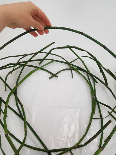 Stack the curved stems to create a wreath shape Stack the curved stems to create a wreath shape