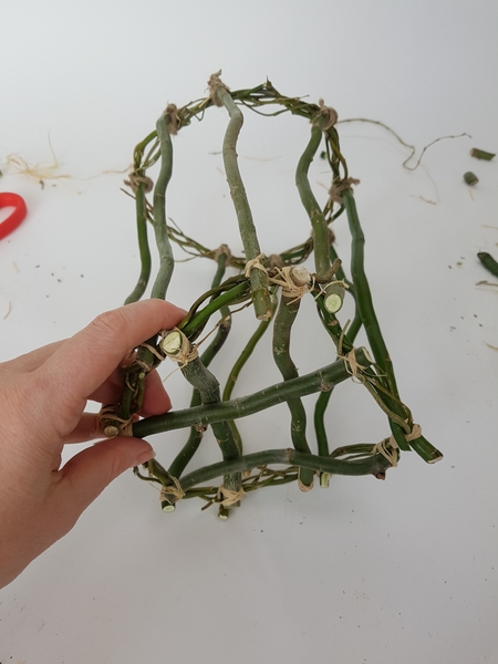 Tie those longer willow twigs to the second wreath. Tie those longer willow twigs to the second wreath.