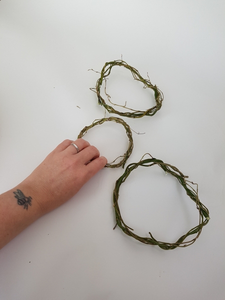 Weave three wreaths (two big and one smaller) from pliable willow twigs. Weave three wreaths (two big and one smaller) from pliable willow twigs.