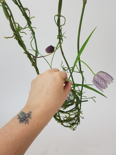 Fill the container with water and place the flowers