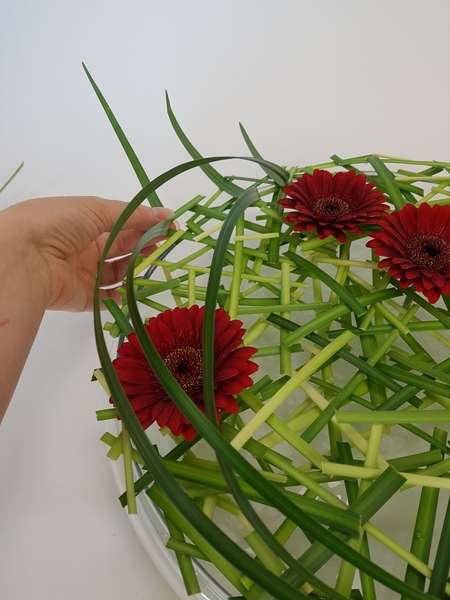 Add a few curving blades of grass. Add a few curving blades of grass.