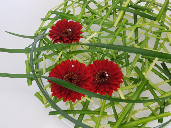 Lily grass and gerbera flower arrangement