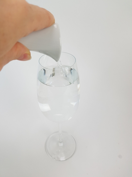 Fill a wine glass with water. Any container with a narrow opening at the top will be perfect for this mechanic. Fill a wine glass with water. Any container with a narrow opening at the top will be perfect for this mechanic.