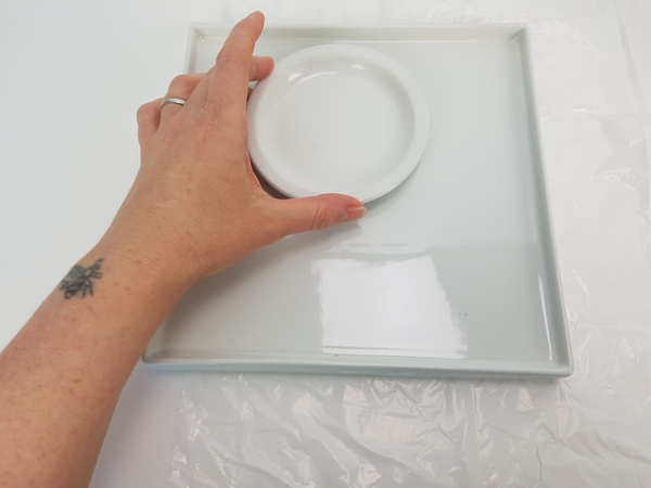 Place a small round plate as a spacer on a serving platter. Place a small round plate as a spacer on a serving platter.