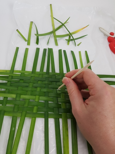 Adjust the weave with a cuticle pusher to open it up. Adjust the weave with a cuticle pusher to open it up.