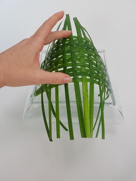 Carefully curve the weave to fit into the square container Carefully curve the weave to fit into the square container