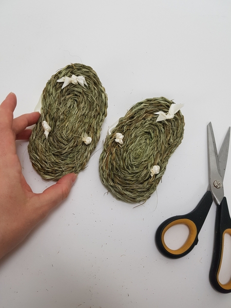 Cut the ribbon ends short and wiggle the knots to sit snugly in the sole. Cut the ribbon ends short and wiggle the knots to sit snugly in the sole.