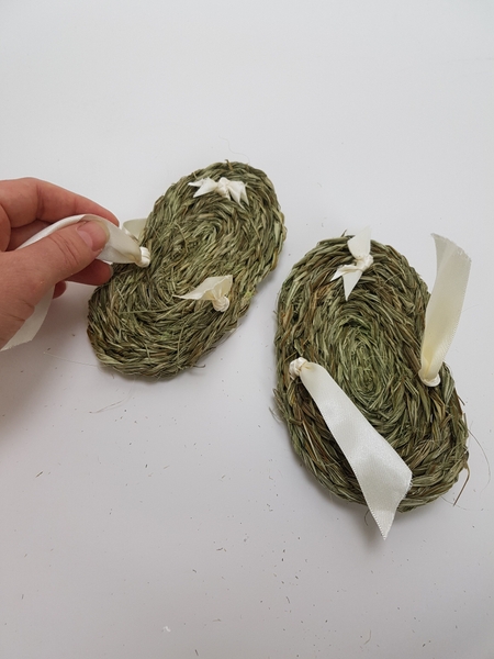 Flip the sandal over and knot around the loop on the side. Flip the sandal over and knot around the loop on the side.