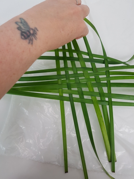Weave in blades of grass to almost the size of your container. Weave in blades of grass to almost the size of your container.