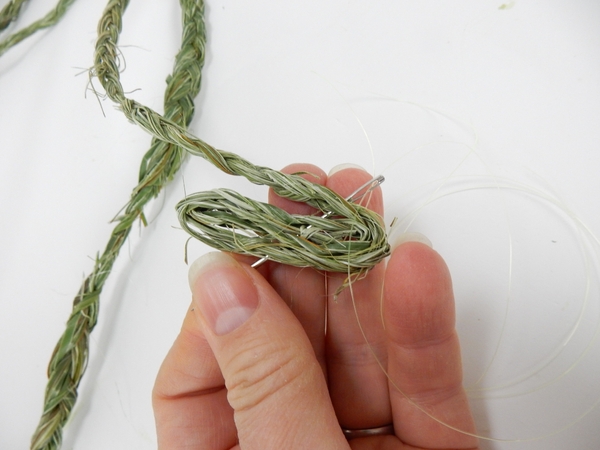 Start to coil the braided flax strand Start to coil the braided flax strand