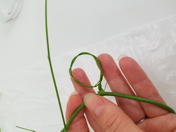 Secure the stem end by pressing the stem end into the wreath Secure the stem end by pressing the stem end into the wreath