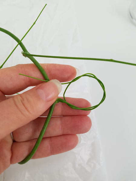 Weave the stem through the loop to create a tiny wreath