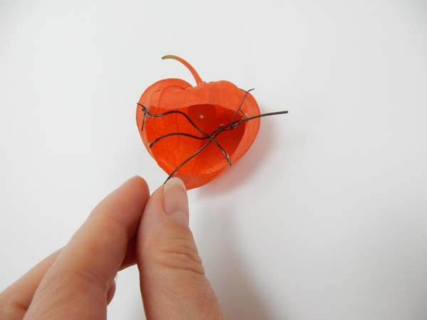Glue in delicate twigs to craft a grid for the flowers to rest on Glue in delicate twigs to craft a grid for the flowers to rest on