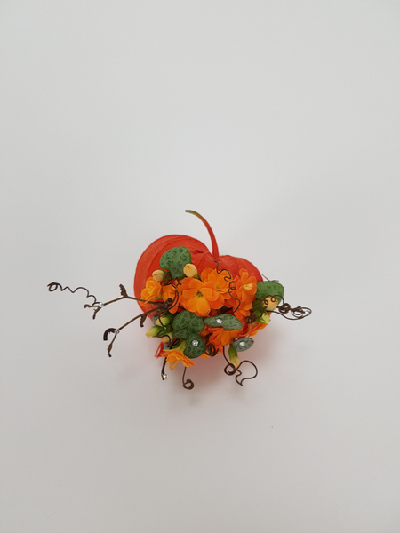 Kalanchoe and rosary vine in a Physalis pod floral art design