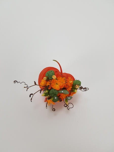 Kalanchoe and rosary vine in a Physalis pod floral art design Kalanchoe and rosary vine in a Physalis pod floral art design