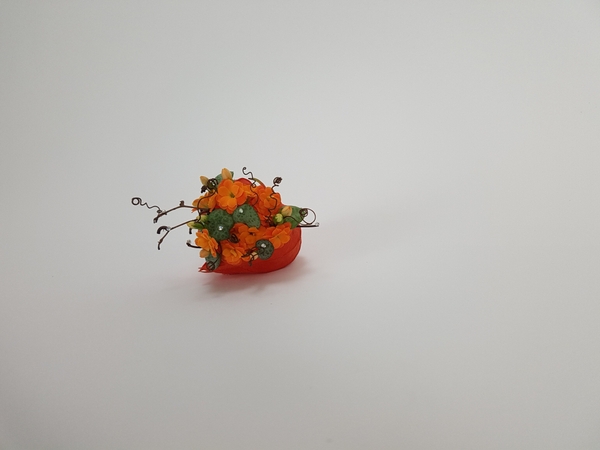 Kalanchoe and rosary vine in a Physalis pod floral design