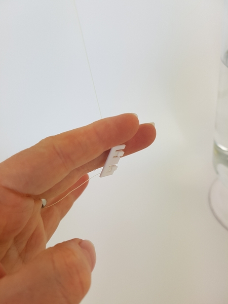 Once the line is woven through it catches and you can easily hang a water tube from the clip Once the line is woven through it catches and you can easily hang a water tube from the clip