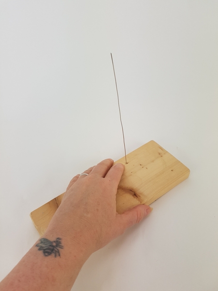 Place the wire in the hole. Place the wire in the hole.