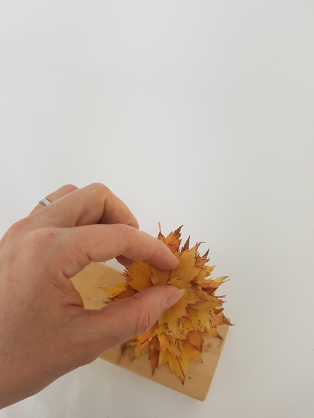 Stack the leaves almost all the way to the top of the wire Stack the leaves almost all the way to the top of the wire