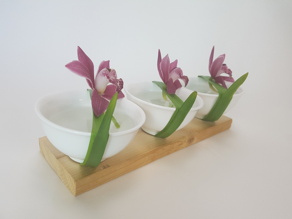Three Cymbidium orchids flower arrangement