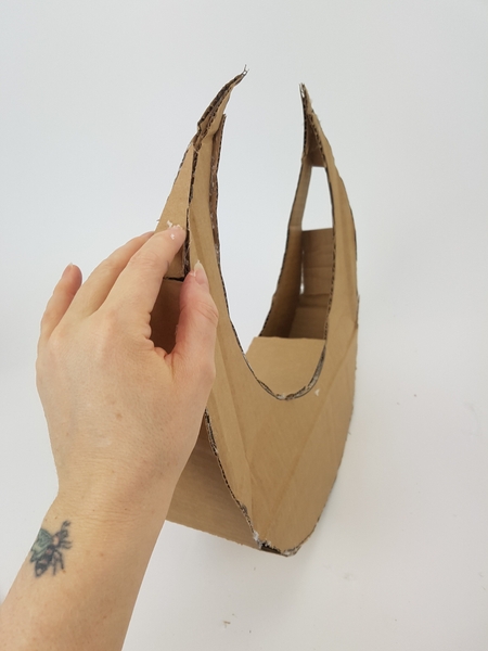 Add a few more strips of cardboard to create a sturdy shape Add a few more strips of cardboard to create a sturdy shape