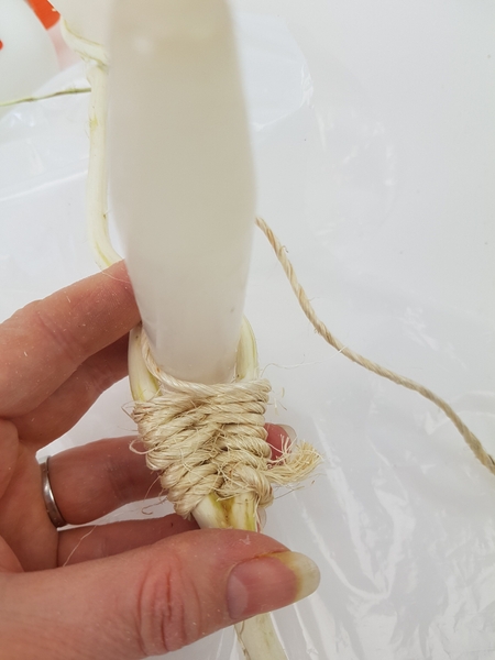 Add tiny drops of glue between the twig and the sisal to keep it set in place Add tiny drops of glue between the twig and the sisal to keep it set in place
