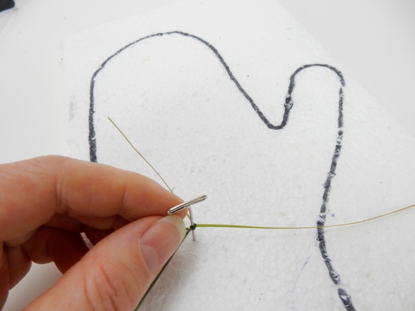 Knot two sections of flax and pin it to the Styrofoam Knot two sections of flax and pin it to the Styrofoam