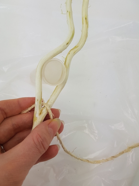 Start at one side to wind the rope around the two twigs Start at one side to wind the rope around the two twigs