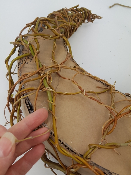 Then wrap pliable willow tips around the thicker stems to secure it in place Then wrap pliable willow tips around the thicker stems to secure it in place