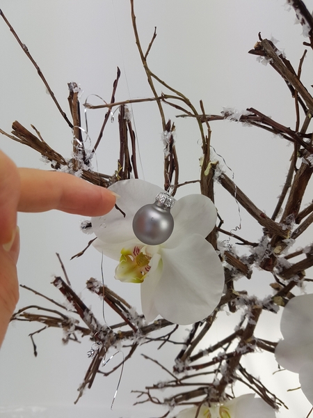 Add thin strands of tinsel Add thin strands of tinsel
